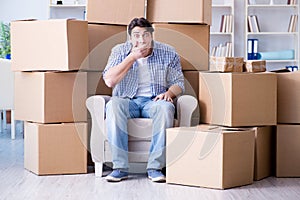 The young man moving in to new house with boxes