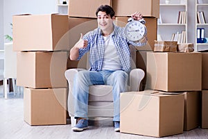 The young man moving in to new house with boxes