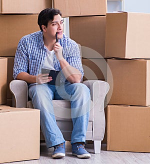 The young man moving in to new house with boxes