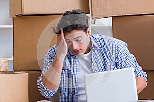 Young man moving in to new house with boxes