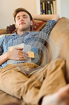 Young man napping on his couch