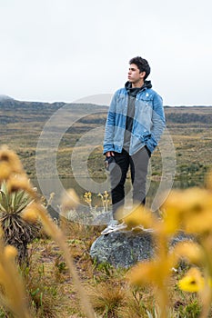 Young man in nature looking at the horizon, intertropical alpine ecosystem photo