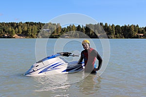 Young man near his jet ski.