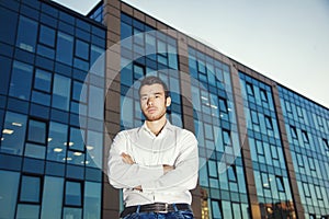 The young man near an office building. Business concept.