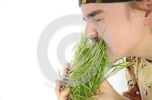 Young man nipping green grass photo