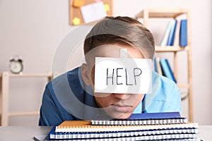 Young man with note HELP on forehead