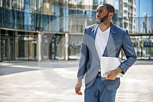 Young man with notebook in city