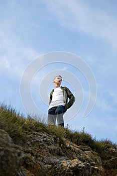 A young man observing the surrounding world from t