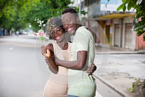 Young man offering a flowers to a beautiful woman