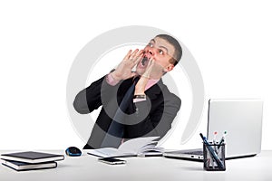 Young man in office shouting with hands cupped to his mouth isolated on white background