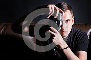 Young man with old camera