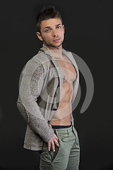 Young man with open jacket on muscular torso