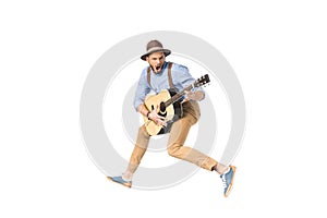 young man with open mouth playing guitar and jumping