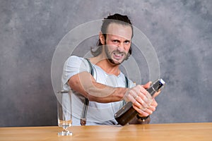 Young man opening a beer bottle