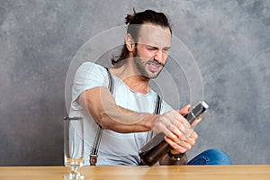 Young man opening a beer bottle