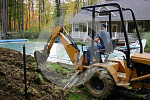Young Man Operating Backhoe