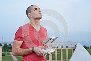 Young man operating a drone remote control console