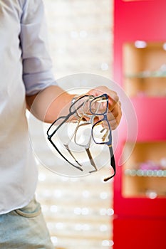 Young man at optician with glasses