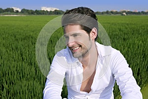 Young man outdoor happy in green meadow
