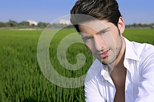 Young man outdoor happy in green meadow