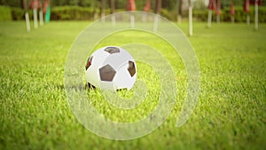 Young man outdoor hit the ball with bare feet close up in summer day