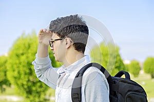 Young man outdoor looking out.