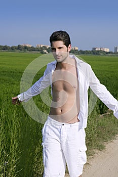 Young man outdoor running in meadow