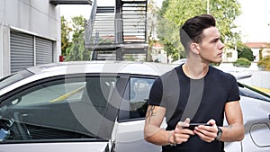 Young Man Outside Car, Lost and Looking for Directions