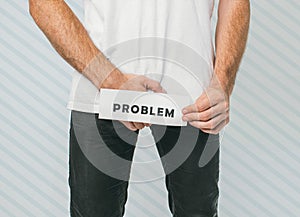 Young man  over background. Guy wants to pee but can`t. Urinal disease. Suffer from pain and uncomfortable