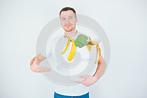 Young man  over white background. Cheerful positive guy hold bucket with organic waste in it. Take care about