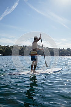 Young Man Paddleboarding photo