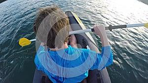 Young man paddling sea kayak