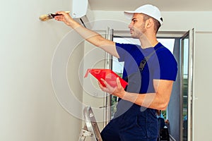 Young Man On Painting Wall With Paintbrush