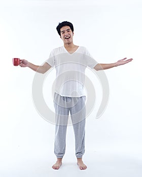 Young man in pajamas with cup of coffee