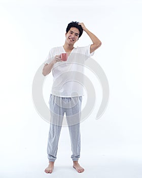 Young man in pajamas with cup of coffee