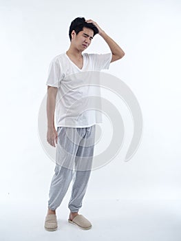 Young man in pajamas on white background