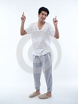 Young man in pajamas on white background