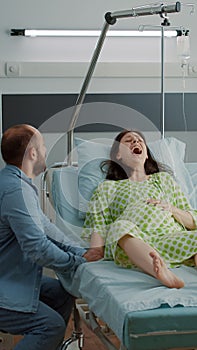 Young man panicking while pregnant wife having contractions