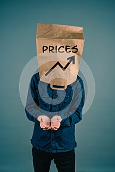 Young man with paper bag on his head, increasing prices, open hands begging for money, finacial crisis, poverty