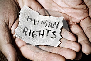 Young man with a paper with the text human rights photo