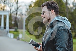 Young man in the park with phone