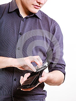 Young man paying by credit card spending money. Finance.