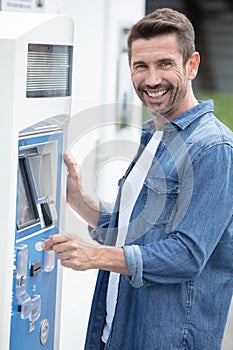 young man paying and waiting for parking ticket