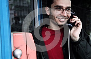 Young man on payphone