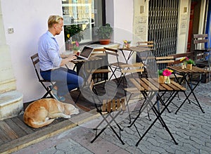 Young man with pc in cafe