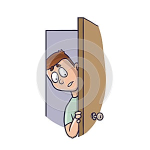 Young man peeking in the slightly open door. Agoraphobia concept. photo