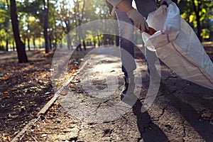 Young man picking up trash