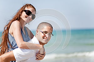 Young man piggyback his girlfriend