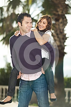 Young man piggybacking his girlfriend