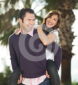 Young man piggybacking his girlfriend